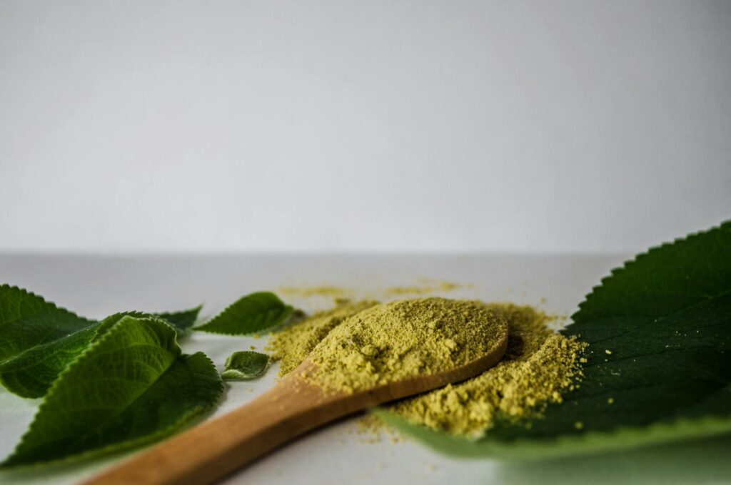 Kratom on a wooden spoon