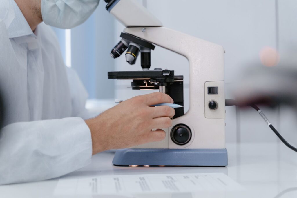 A researcher looking into a microscope
